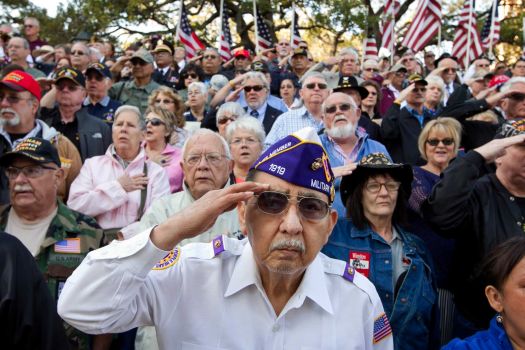 Vietnam veteran Frank Cortez salutes during the national anthem at Saturday's the dedication of the Texas state Capitol Vietnam Veterans Monument in Austin.